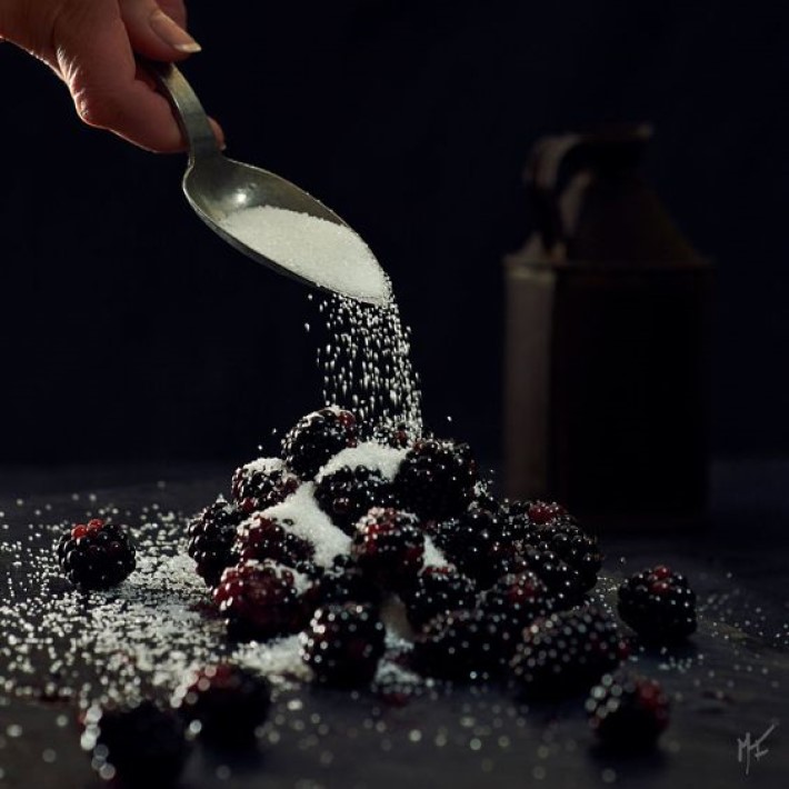 sugar being poured on blackberries, visual storytelling photography by marco joe fazio