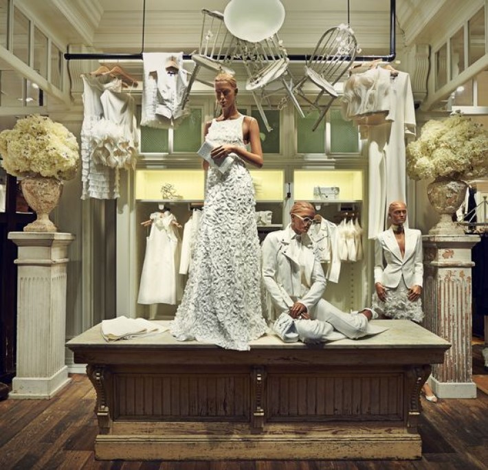 a white retail store setting with mannequins dressed in all white and white chairs hanging from the ceiling, visual storytelling by marco joe fazio