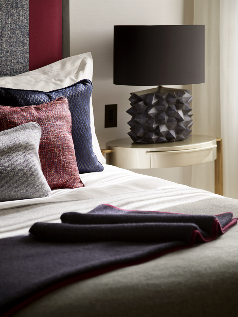 Detail of bedroom with a unique black table lamp in a Playful Interior by Elycion