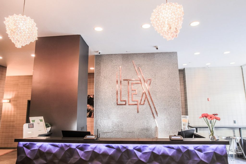 lobby of the lex hotel nyc with a purple reception desk - a top boutique hotel in nyc