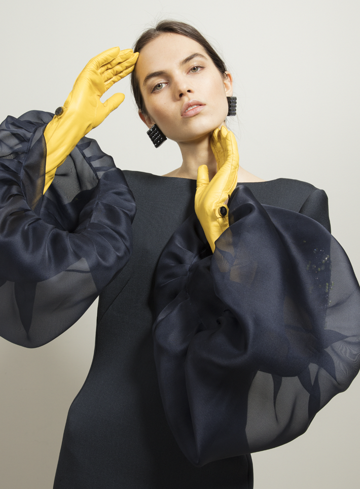 photograph of a beautiful woman in a black dress with yellow leather gloves by sabine villiard for lanvin fall - winter 2018 - history of jeanne lanvin