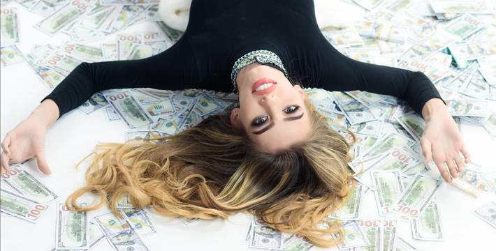 50 30 20 rule - rich sexy woman laying in money