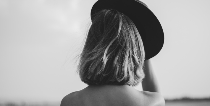 how to get over past mistakes - woman taking off her hat from back - sway style - unsplash