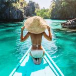 travel books to love woman in a straw hat on boat in philippines