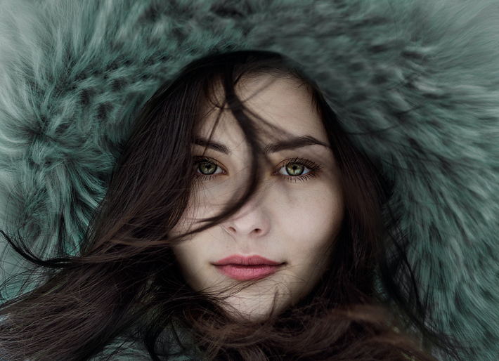 classic no-makeup look woman in fur hood with beautiful skin