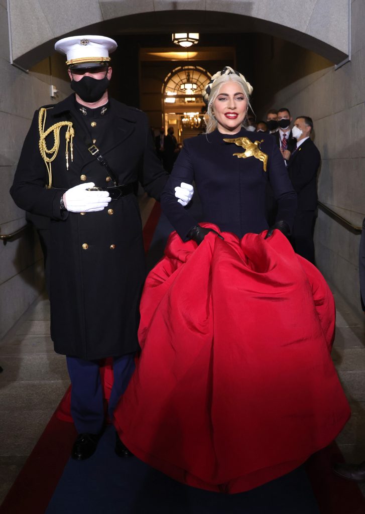 WASHINGTON, DC - JANUARY 20: Lady Gaga is escorted by U.S. Marine escort Capt. Evan Campbell to sing the National Anthem at the inauguration of U.S. President-elect Joe Biden on the West Front of the U.S. Capitol on January 20, 2021 in Washington, DC.  During todays inauguration ceremony Joe Biden becomes the 46th president of the United States. (Photo by Win McNamee/Getty Images)