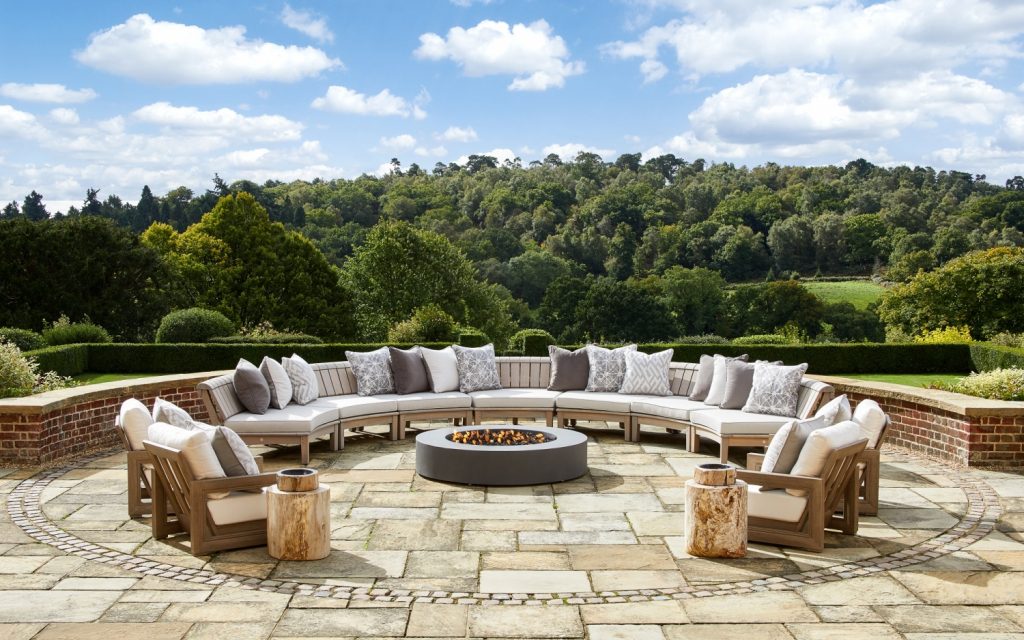Surrey Hill residence designed by London Projects large c shaped outdoor sofa with round fire pit