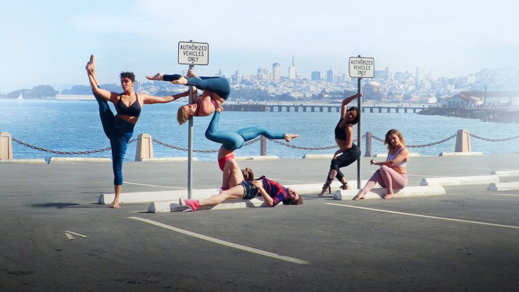 Scene from Strip Down, Rise Up woman standing in front of city
