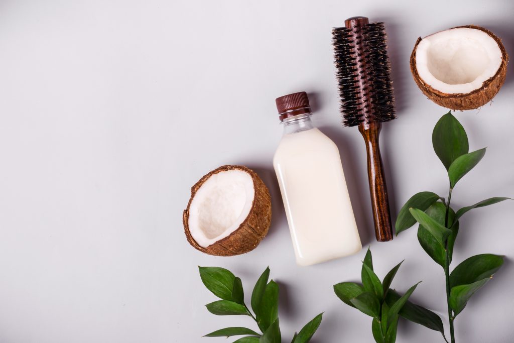Coconut oil and tropical leaves. proper Hair care spa concept