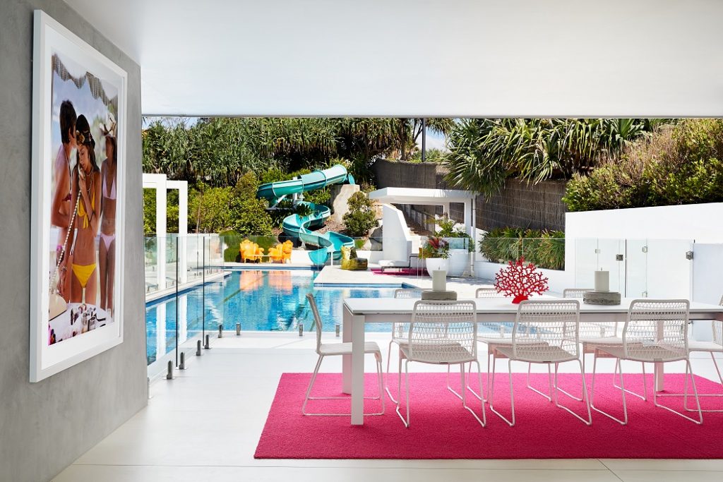 luxury outdoor dining room by pool white with pink carpet