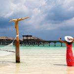 woman on the beach in maldvies luxury resort zeldiva luxury travel