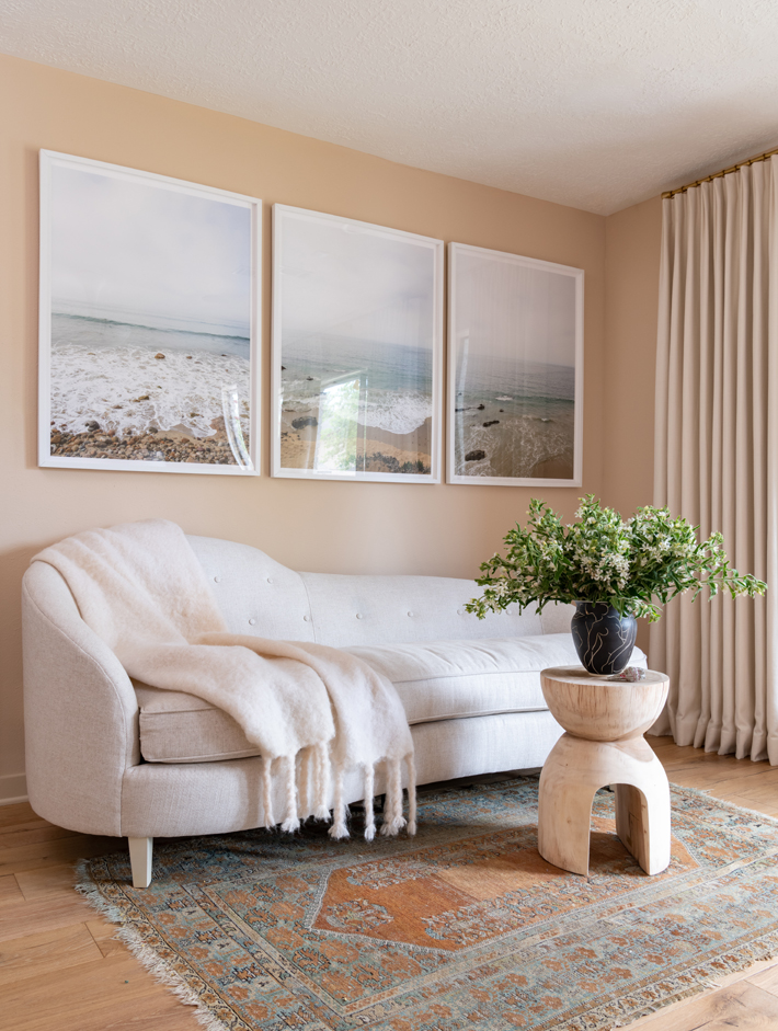 neutral sitting room with beach art