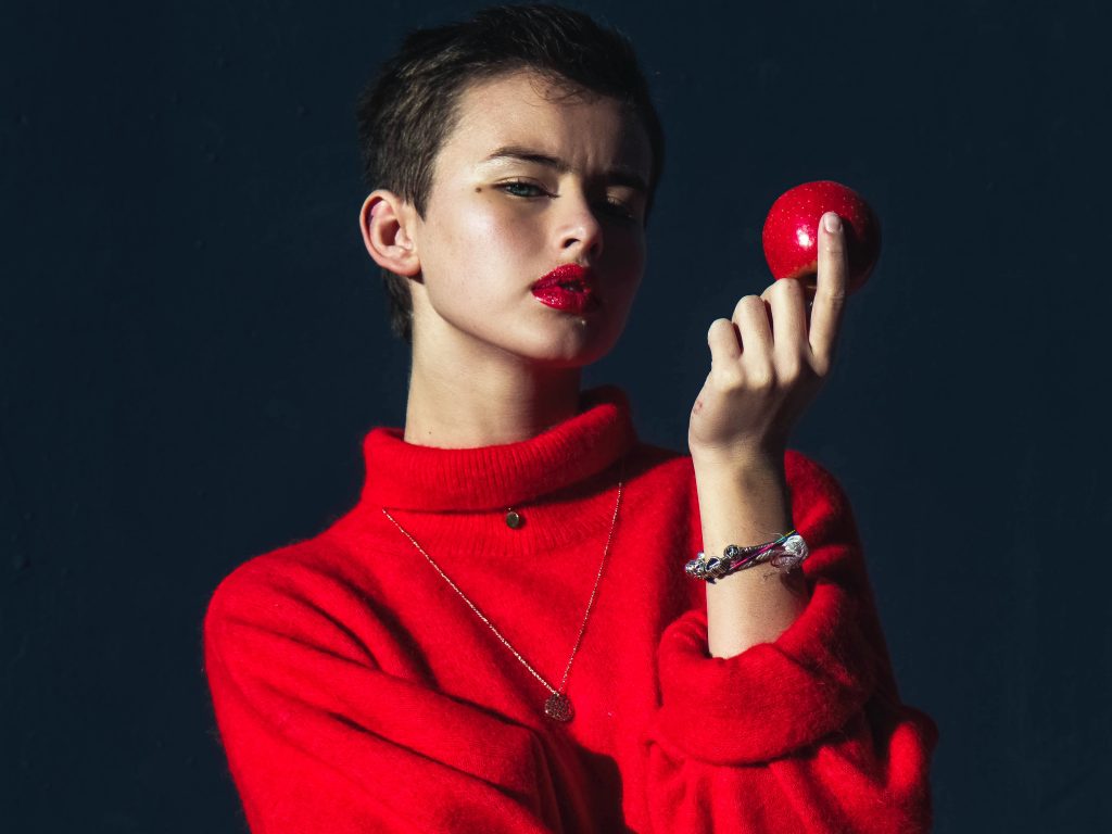 how to train your brain woman holing red ball apple Photo by Justin Essah | Unsplash