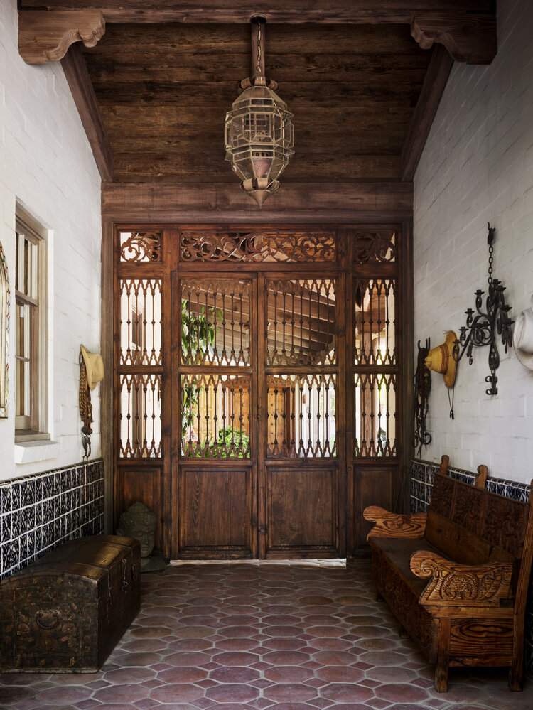 bohemian entry Rainn Wilson & Holiday Reinhorn residence designed by Interior Archeology Spanish Hacienda (Featured in AD Online / Photos by Douglas Friedman)