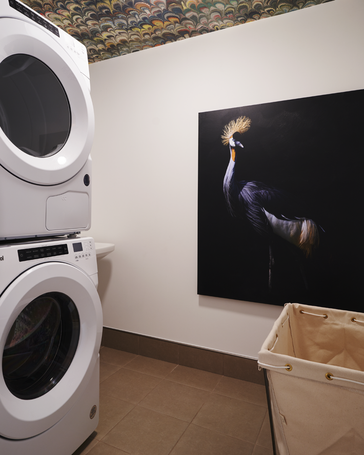 laundry room with wallpaper ceiling and art