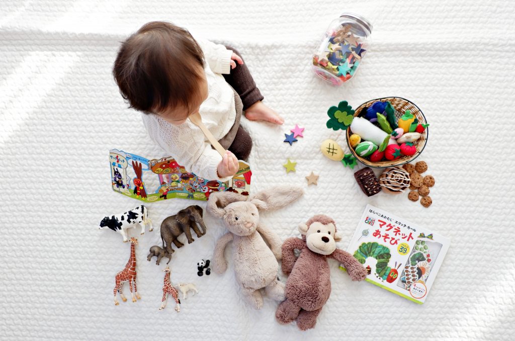 toddler playpen ideas photo by yuri shirota unsplash baby playing on white blanket