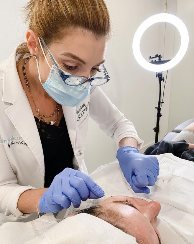 nurse Christy Adams threading a client's face