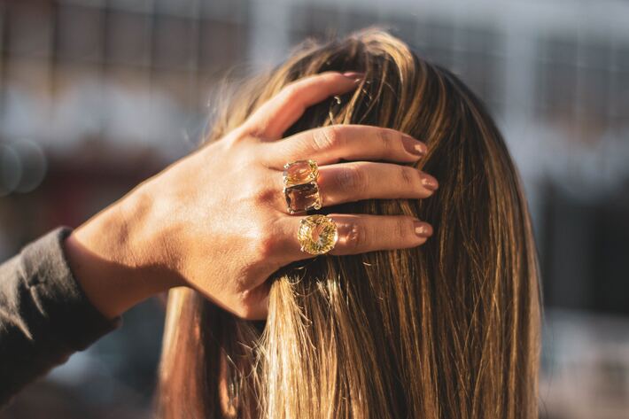 woman wearing bold statement rings photo by lucas lenzi
