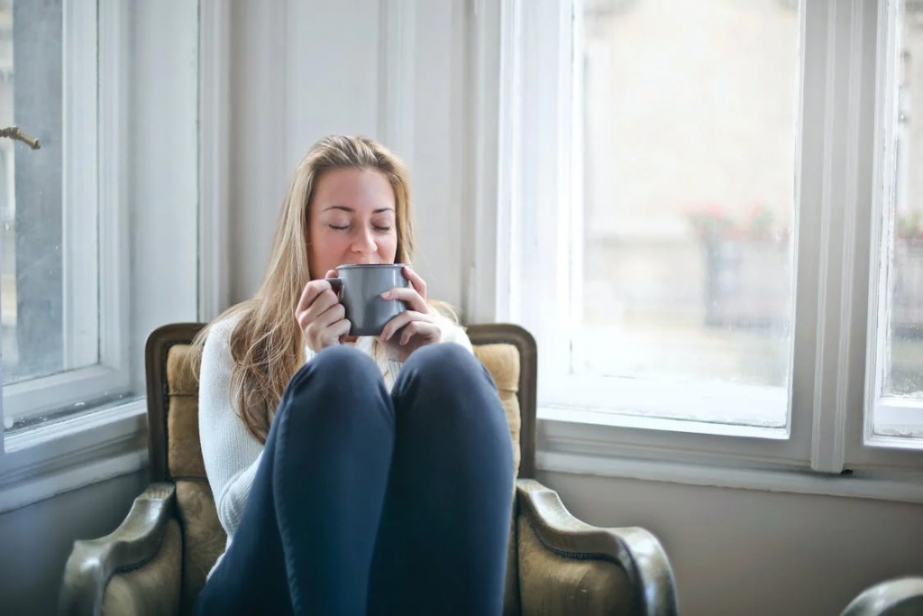 Woman relaxing in her home with a cup of coffee