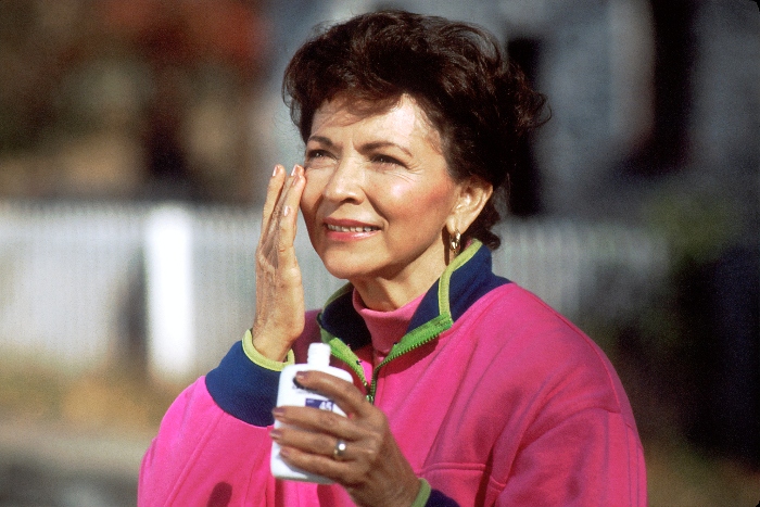 Female applying sunscreen