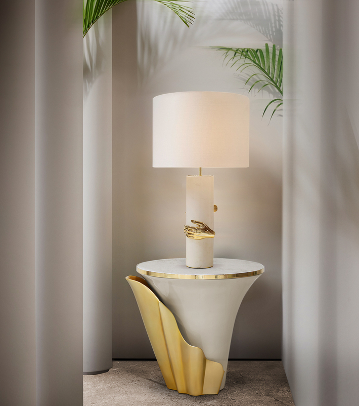 koket yasmine side table white lacquer, marble and polished brass gold finish with a marble table lamp with a gold polished brass hand
