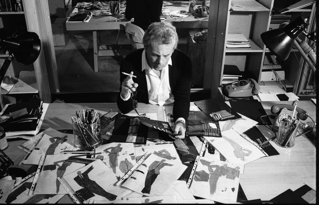 Italian fashion designer Giorgio Armani (1934 - 2025), examines drawings for new designs, late 1970s. (Photo by David Lees/Corbis/VCG via Getty Images)