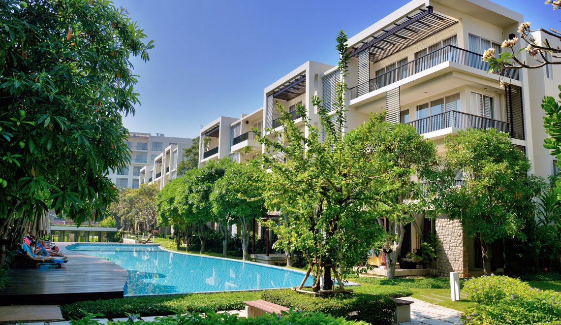 Green trees near swimming pool during day time