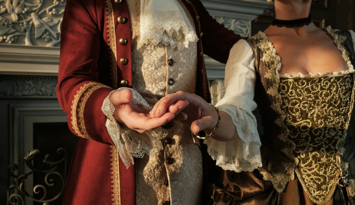 a man and a woman dressed in period costumes