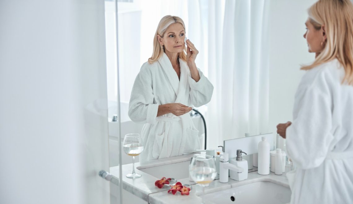 woman in the bathroom taking care of her skin
