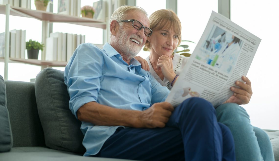 happr senior couple reading the newspaper