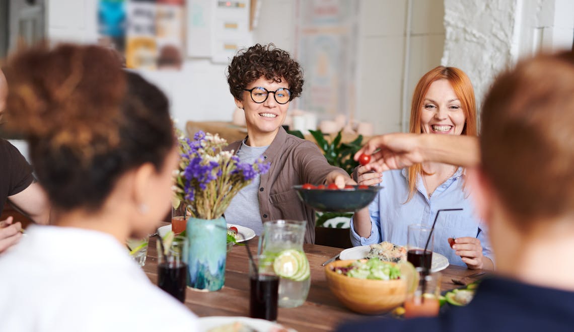 people sitting around a table sharing food