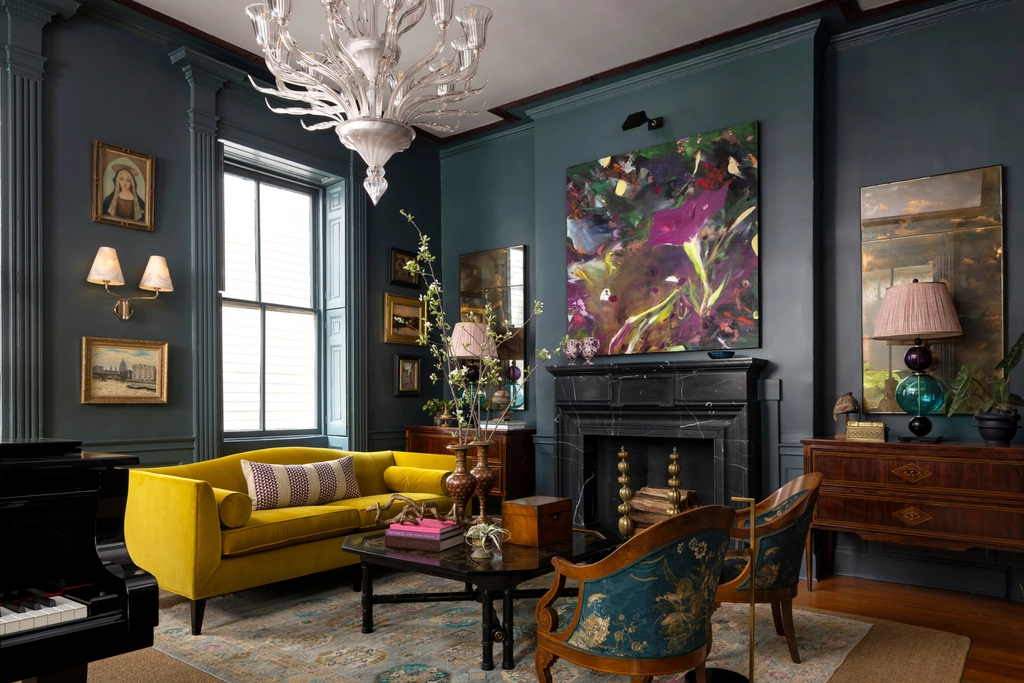 Symphony Showhouse room designed by Michael Mitchell | photo by molly rose - yellow sofa, black marble fireplace, steel blue walls, bold statement artwork interior design mixing old and new