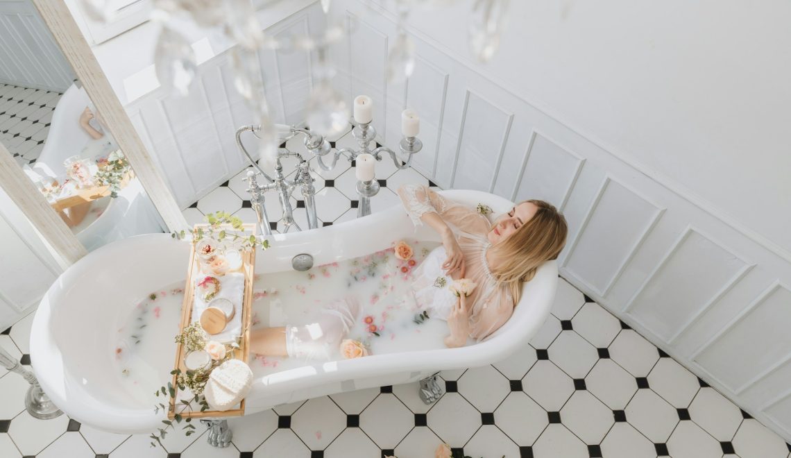 A woman laying in a bathtub