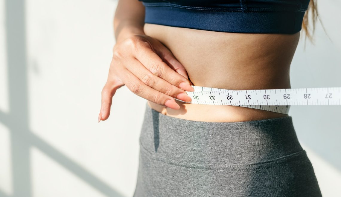 woman measuring waist