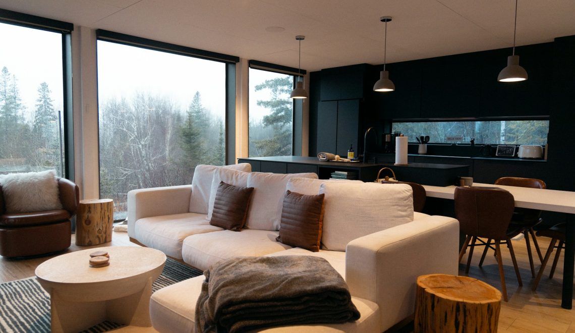 A living room filled with furniture and large windows