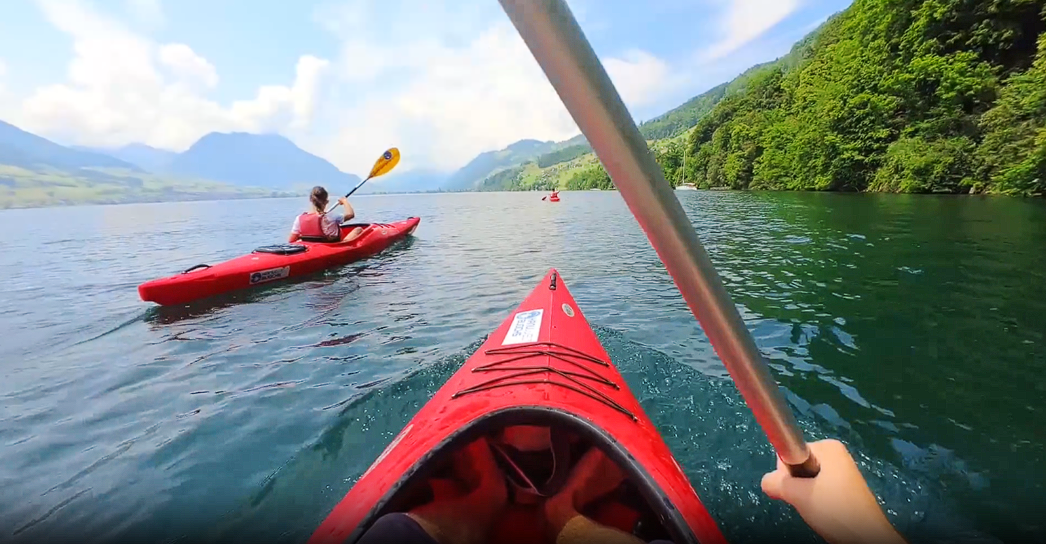 two people sitting on boats and paddling the water