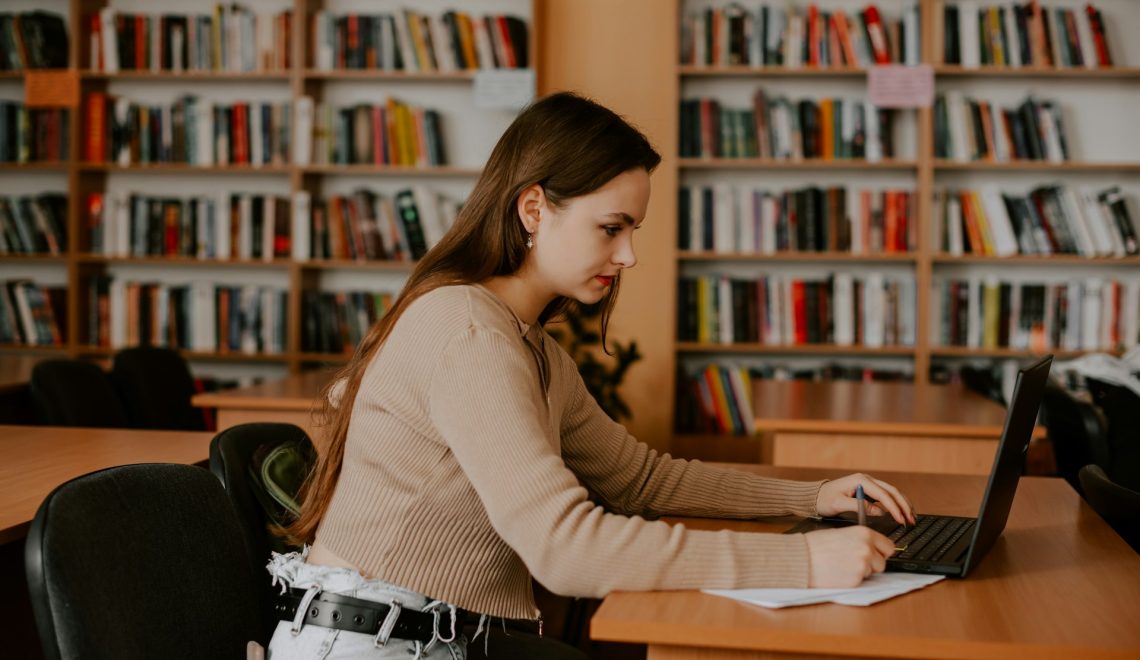 A woman sitting at a desk using a laptop
