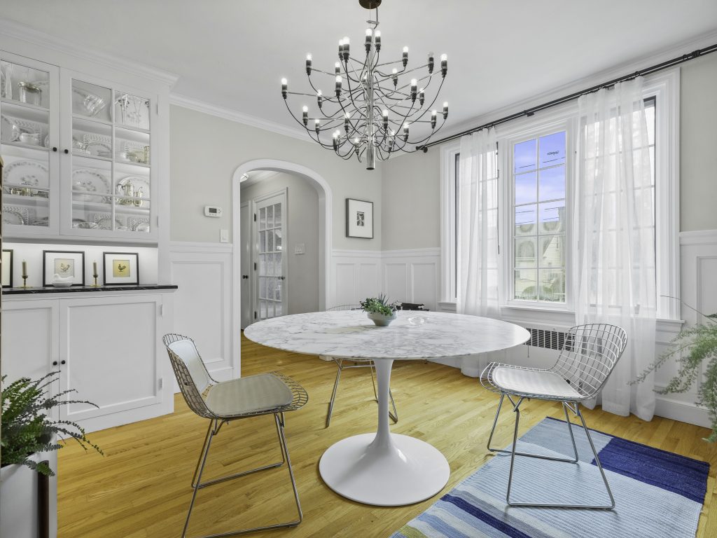 White kitchen eating area with marble table Sustainable Interiors
