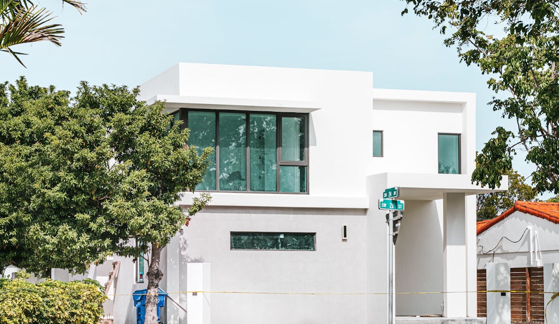 white concrete building near green tree
