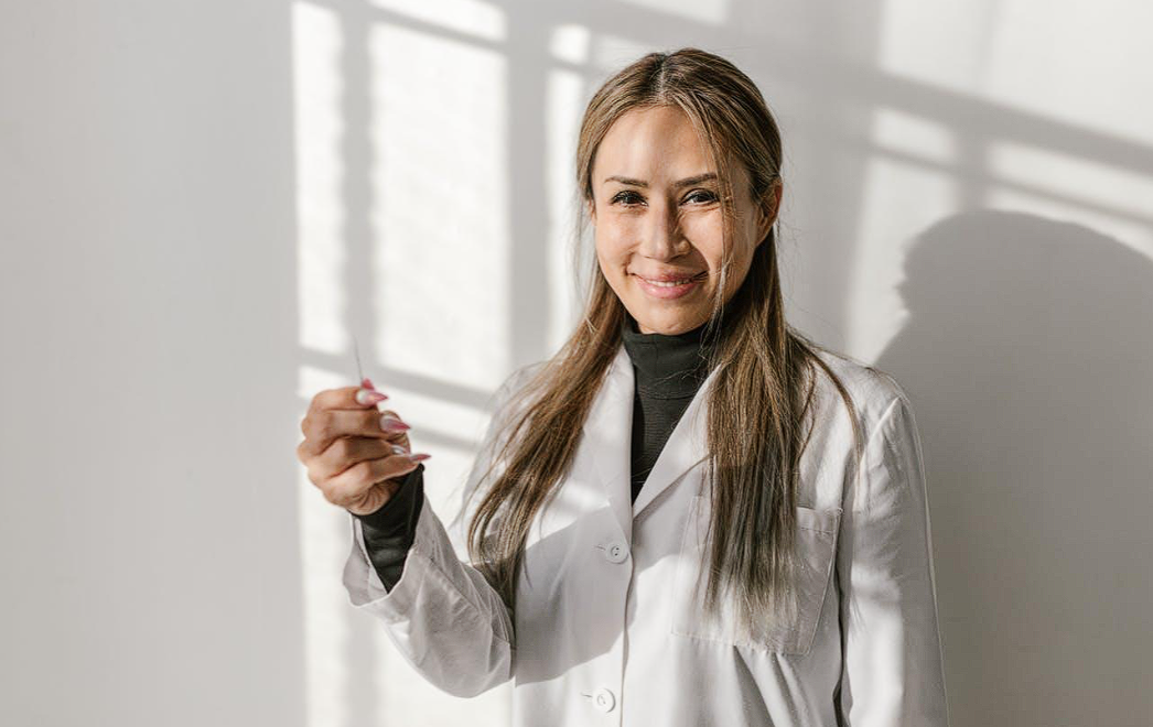 woman with a white coat smiling