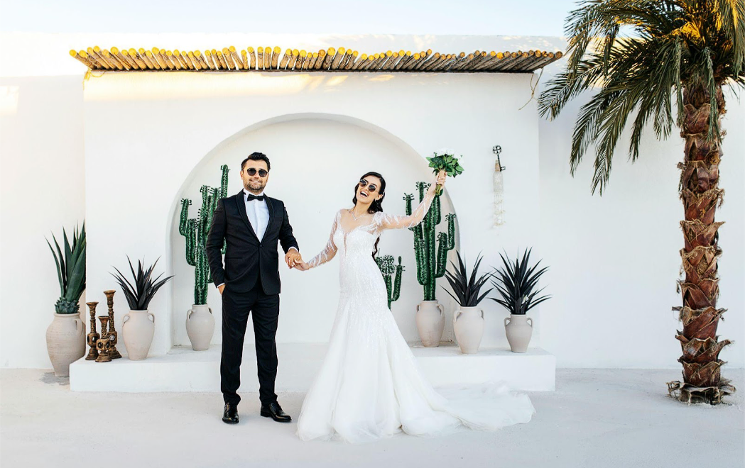 A man and a woman wearing sunglasses in their wedding