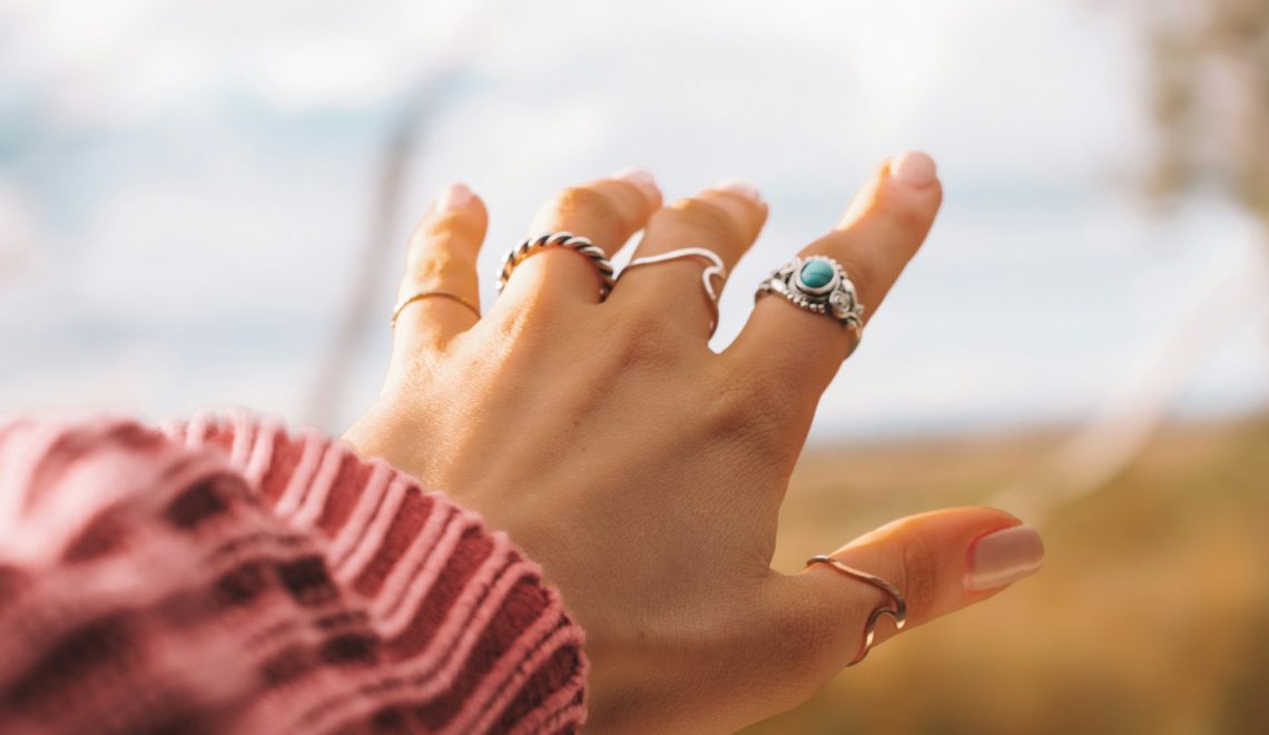 a woman's hand with five rings