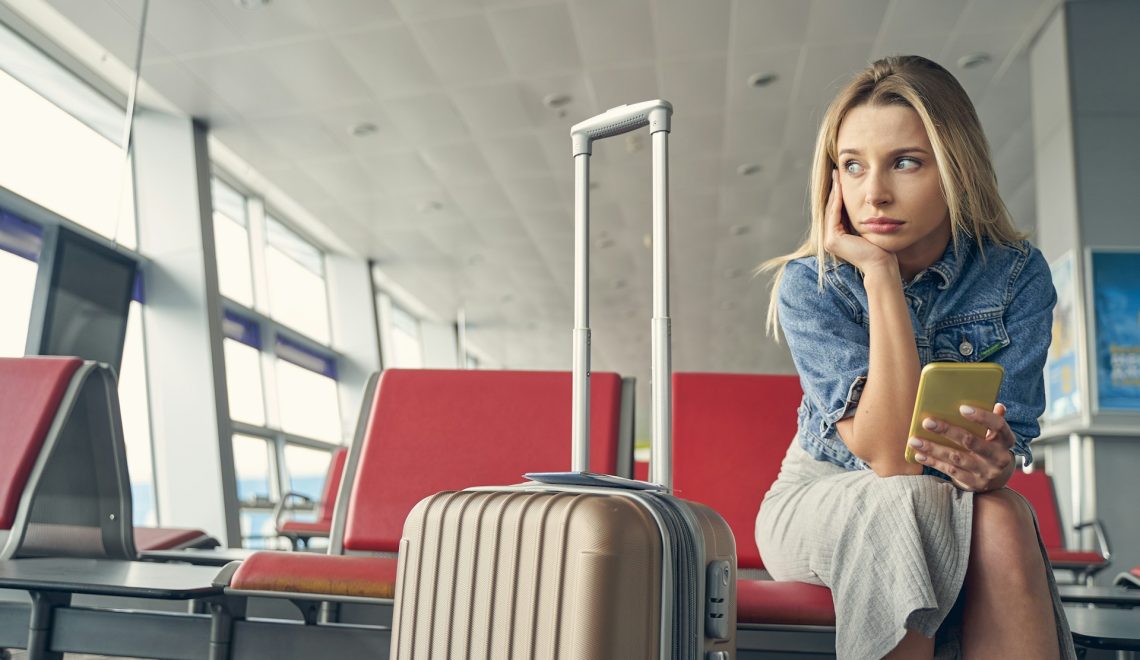 woman sitting on a red chair at the airport