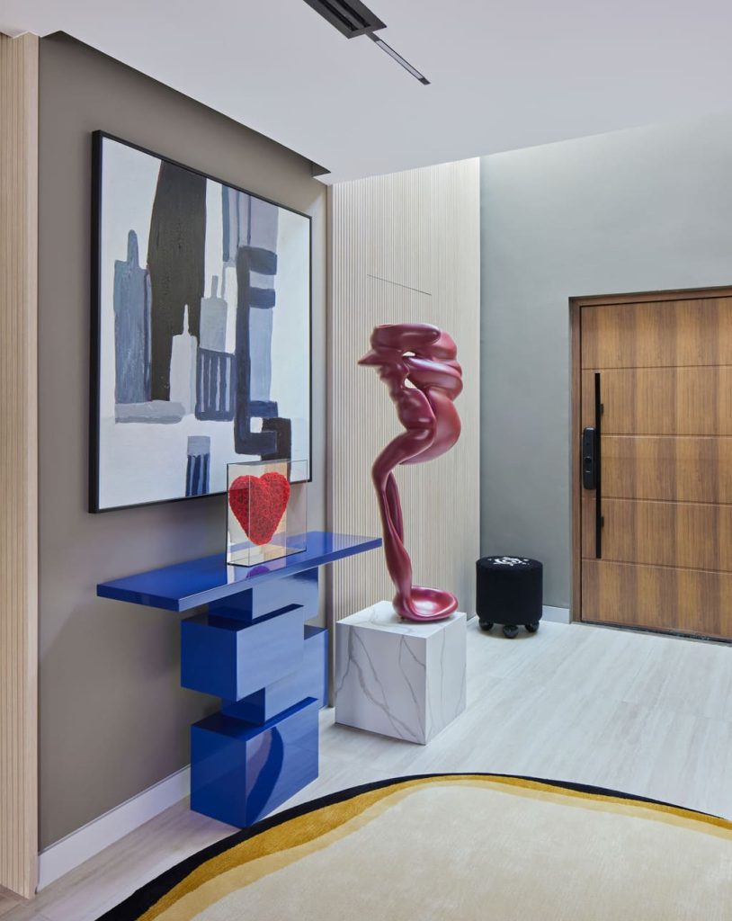 Dubai Villa design by Emre Osmanlar - modern eclectic foyer with blue console table and unique art