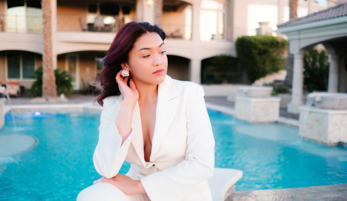 Woman sitting in front of a swimming pool