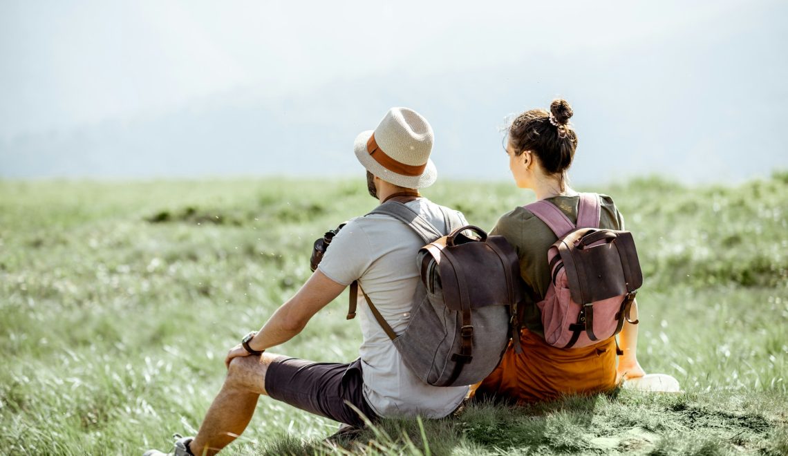 couple sitting on a green meadow
