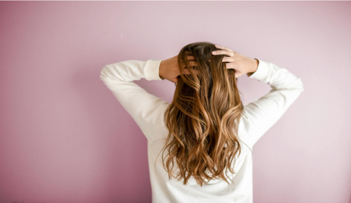 woman with long wavy hair viewed from behind