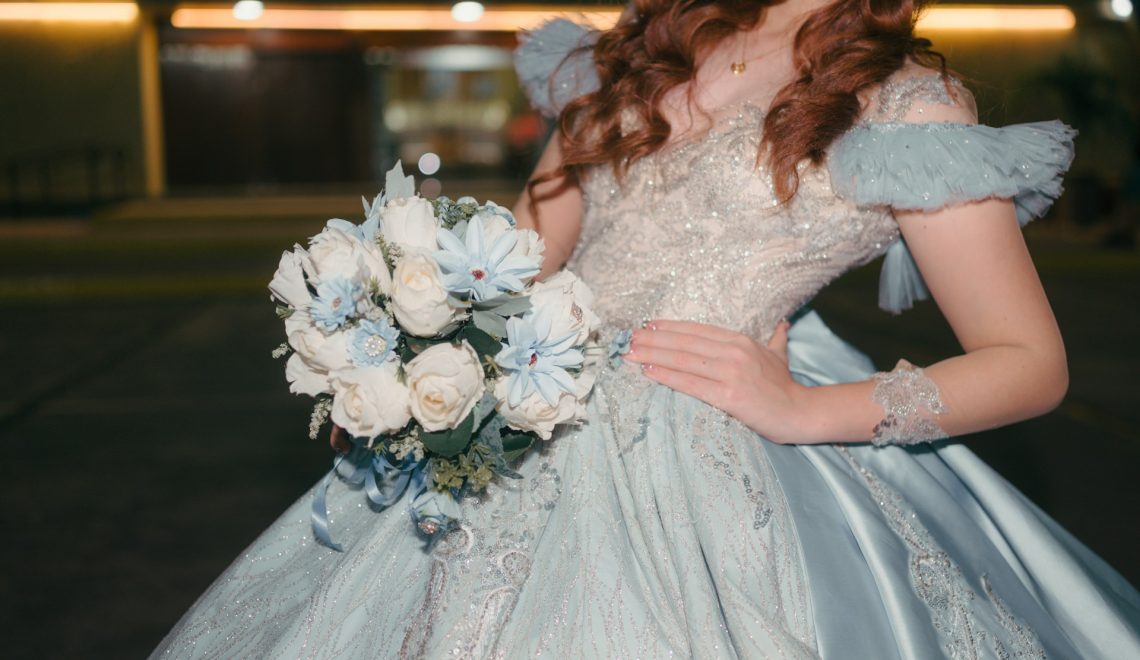 Woman in a light blue dress holding a bouquet