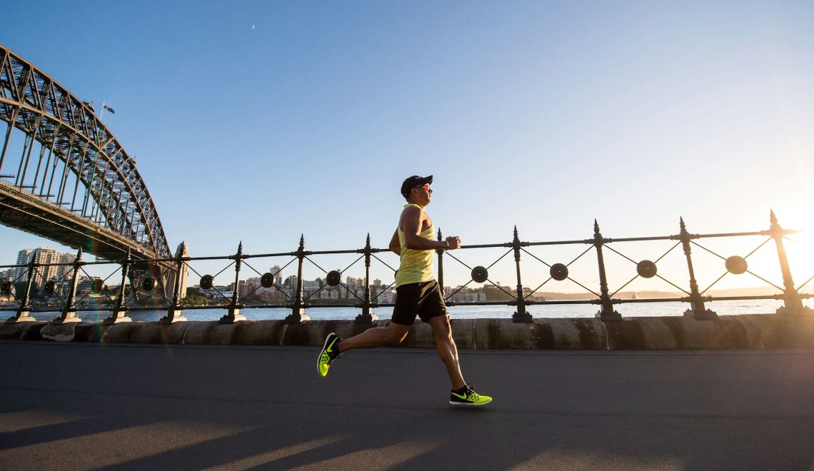 man in a yellow tank top running