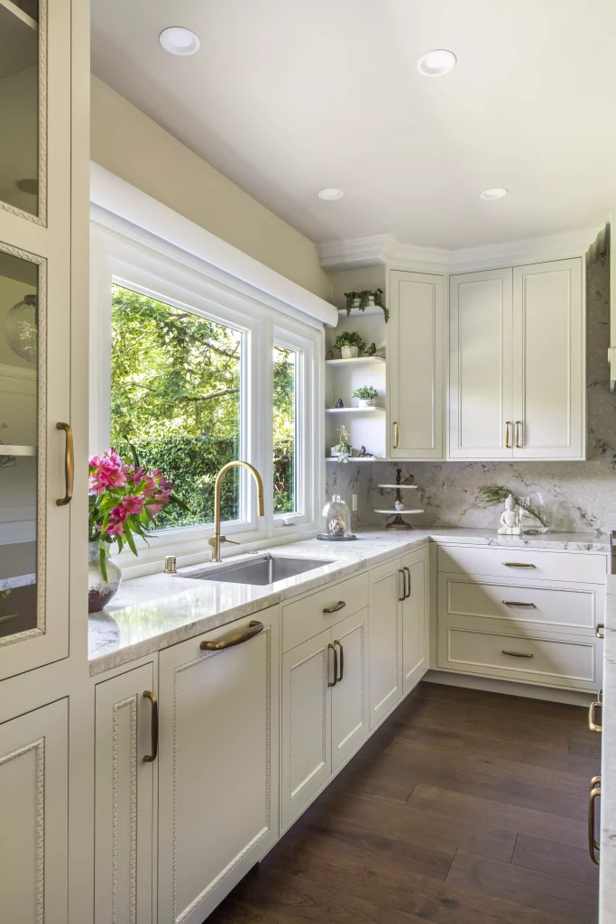 luxury kitchen with white cabinets and brass hardware mauve quartz counter